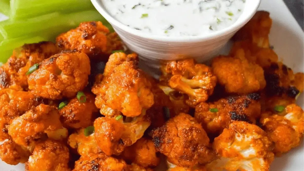 Crispy buffalo cauliflower bites with ranch dip, perfect for a game day snack.