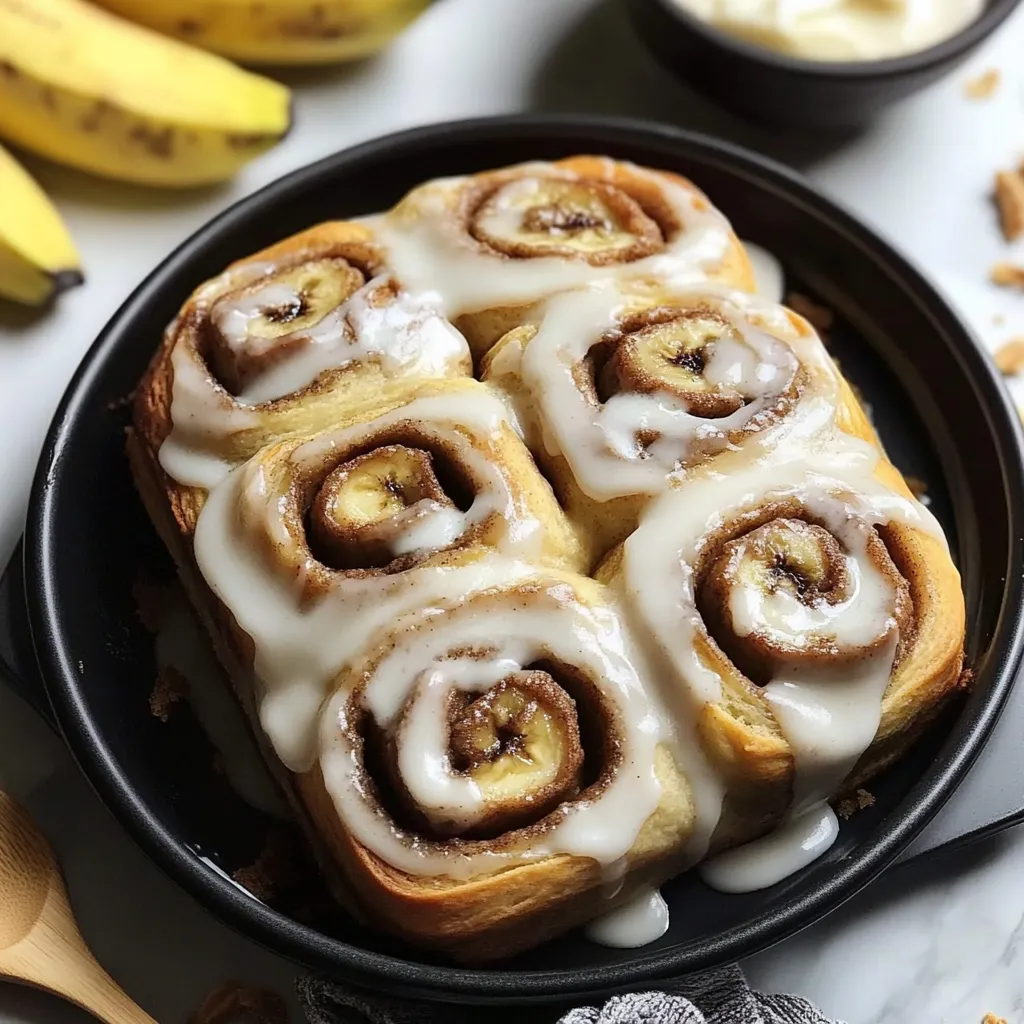 Warm banana bread cinnamon rolls with sweet glaze.