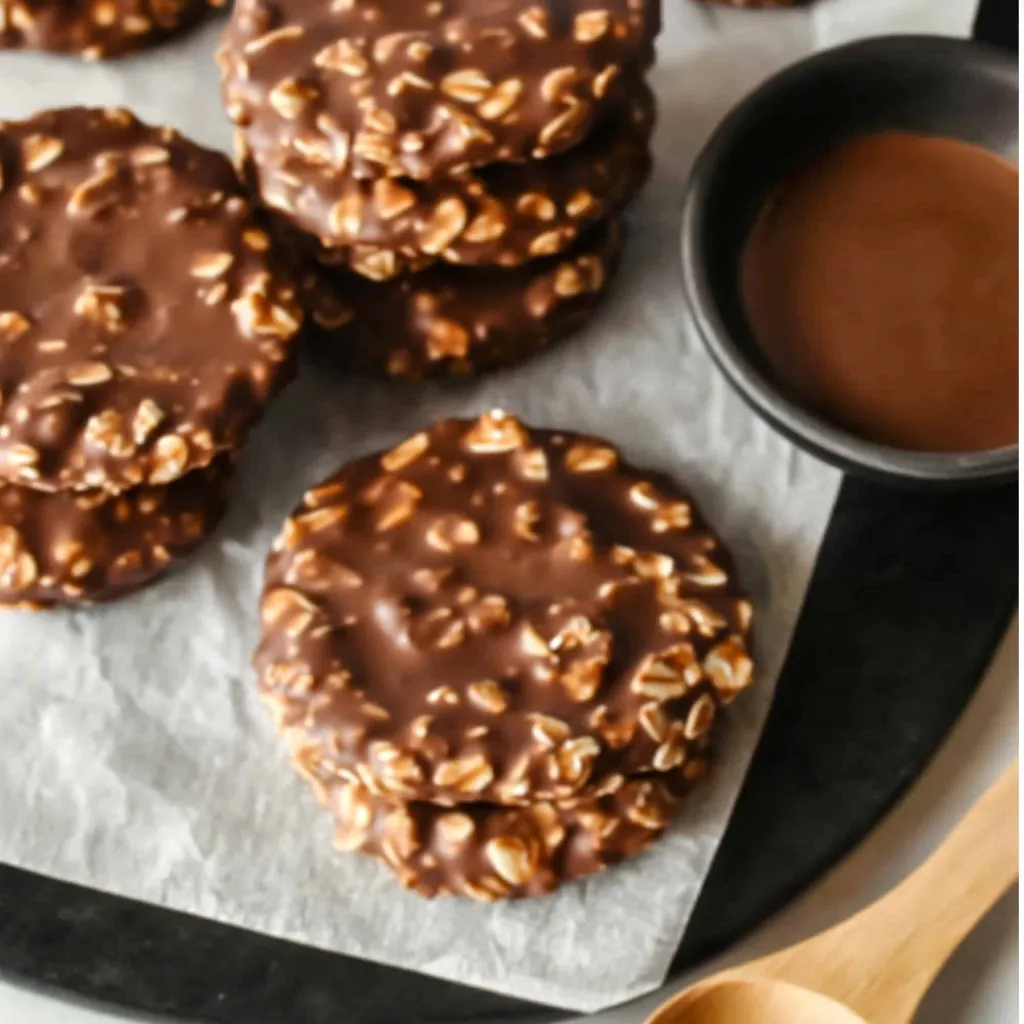 No-bake chocolate peanut butter cookies stacked on a plate.