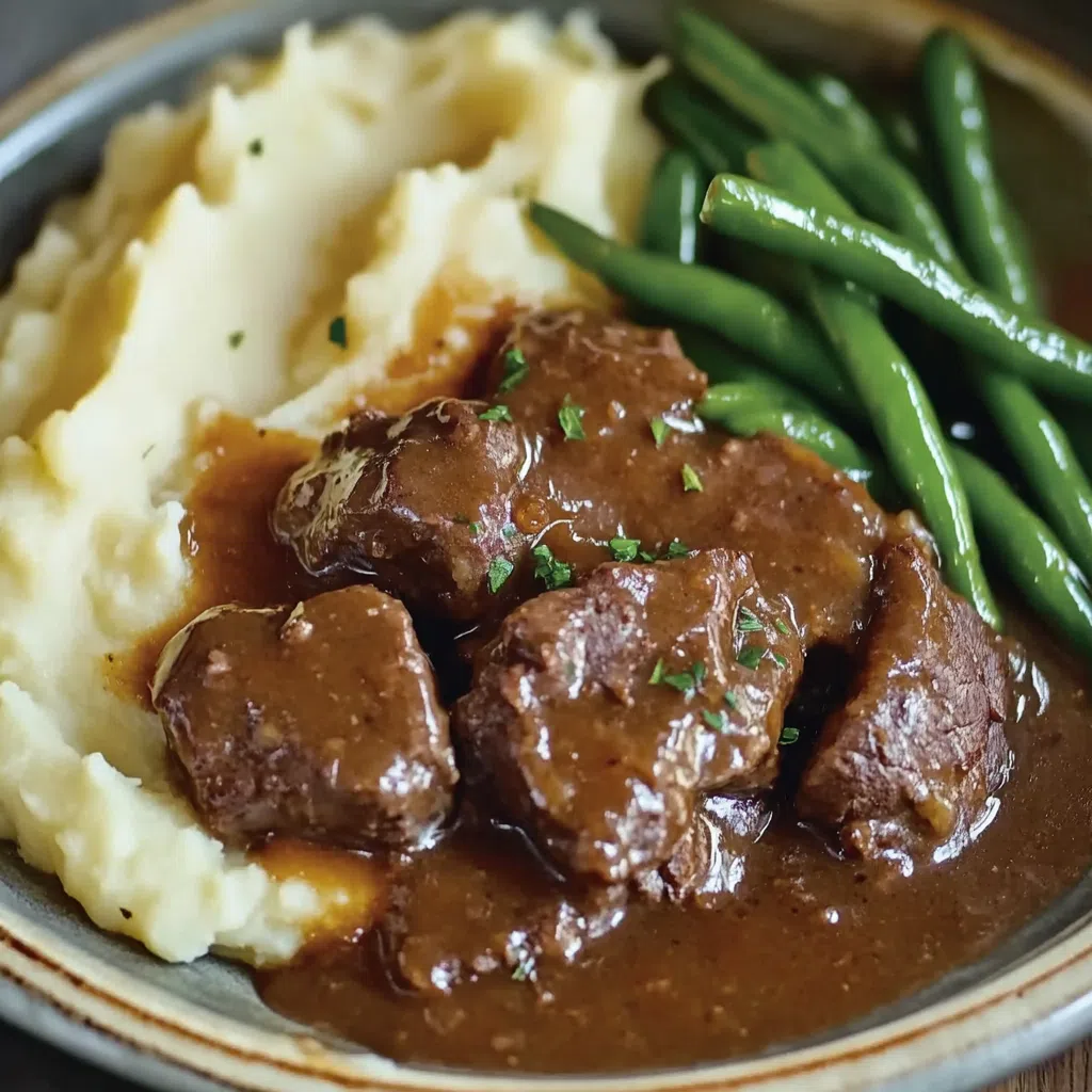 Tender cube steak with gravy, slow-cooked in a crockpot.