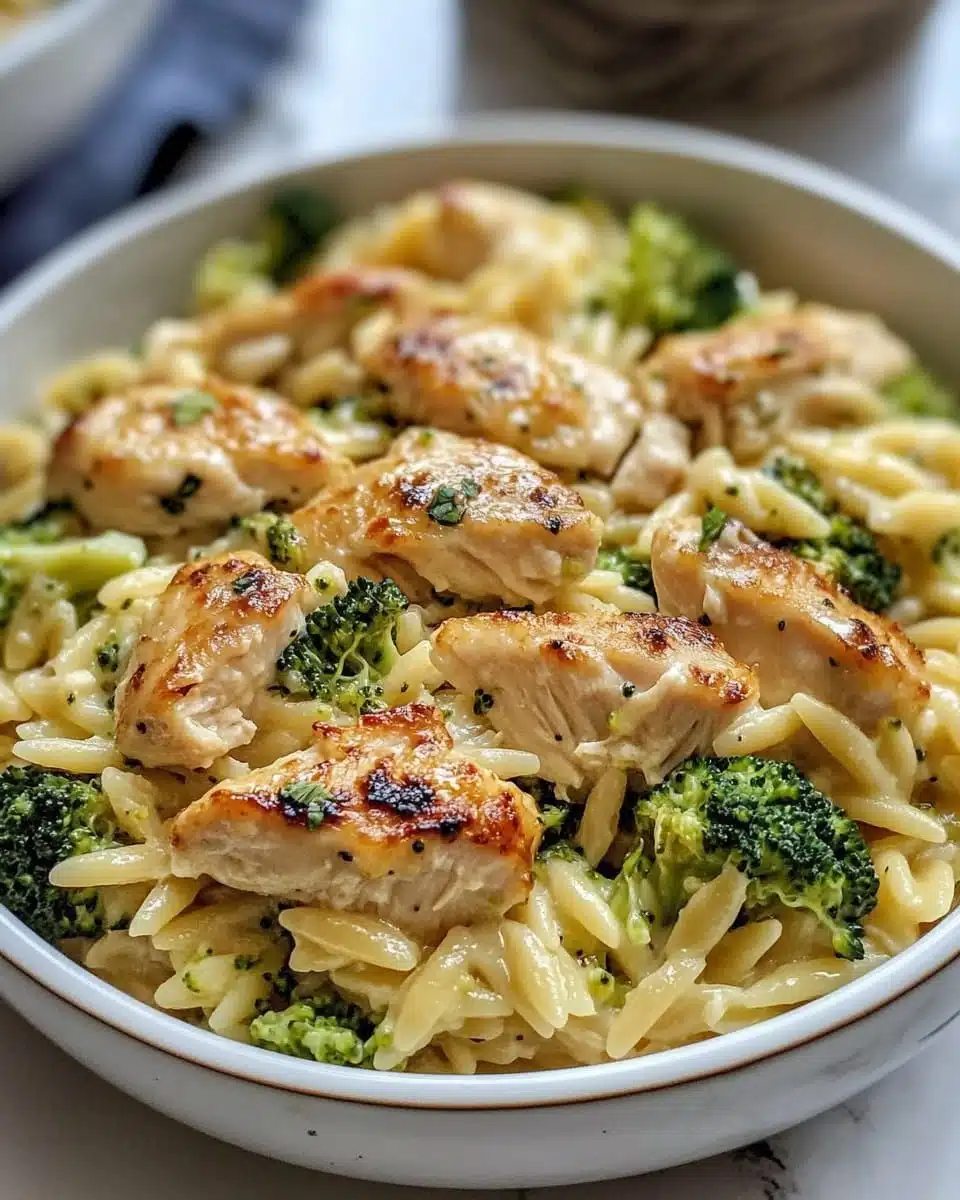 Creamy broccoli cheddar chicken orzo in a one-pan dish.