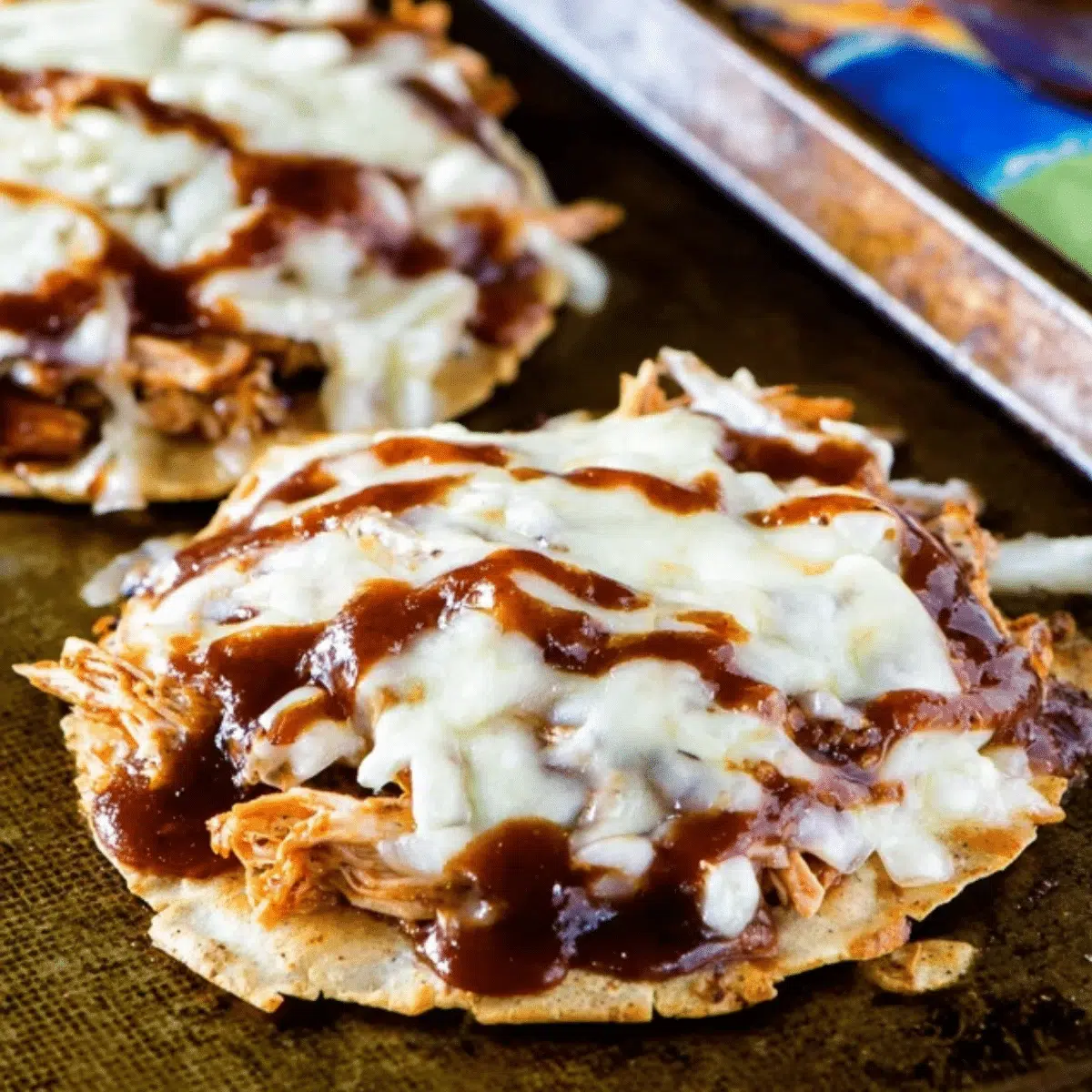 Crispy BBQ chicken tostadas topped with fresh cilantro and avocado for a quick 30-minute dinner.