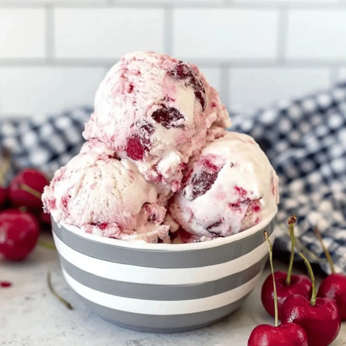 Creamy homemade cherry vanilla ice cream in a bowl with fresh cherries