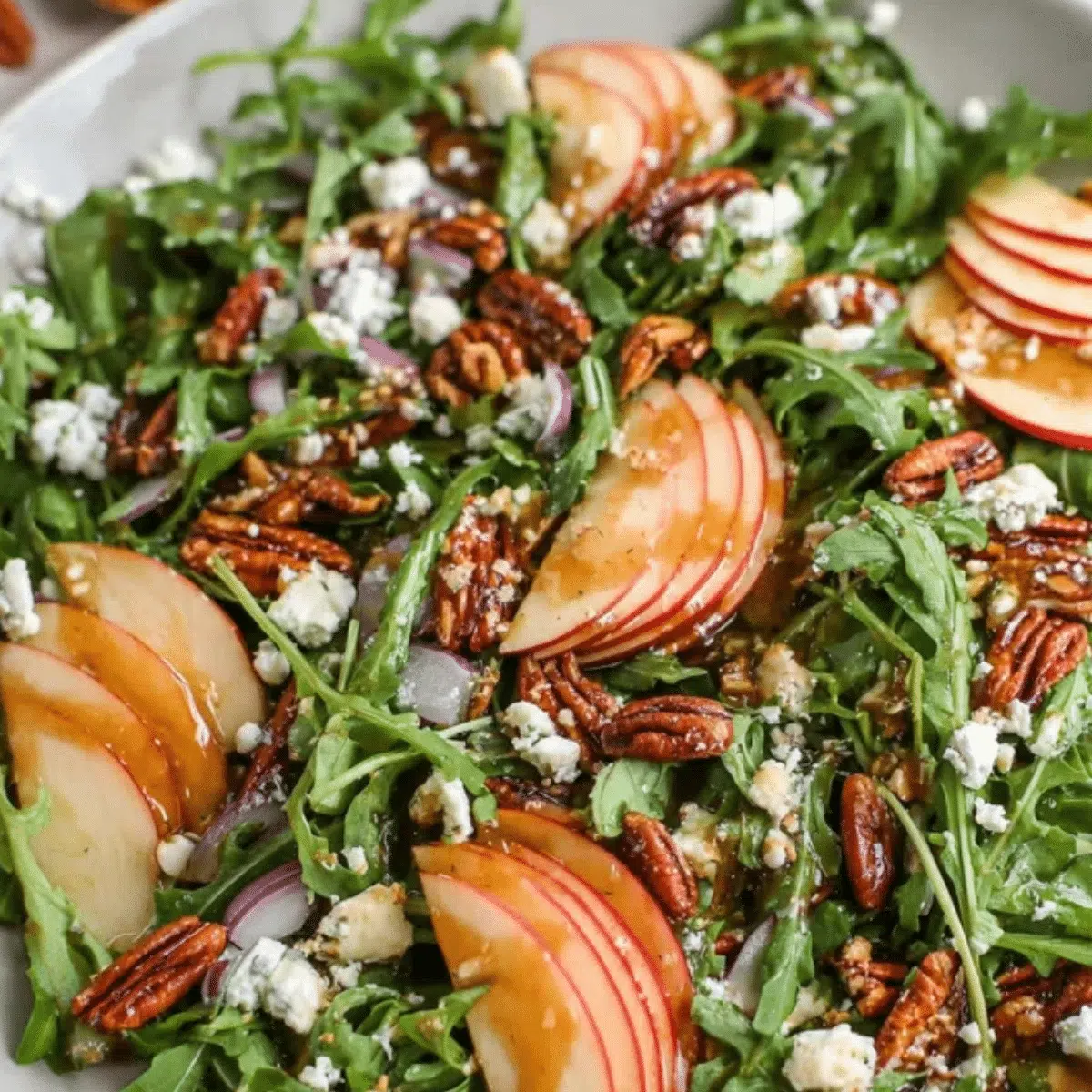 Refreshing apple arugula salad with maple pecans.
