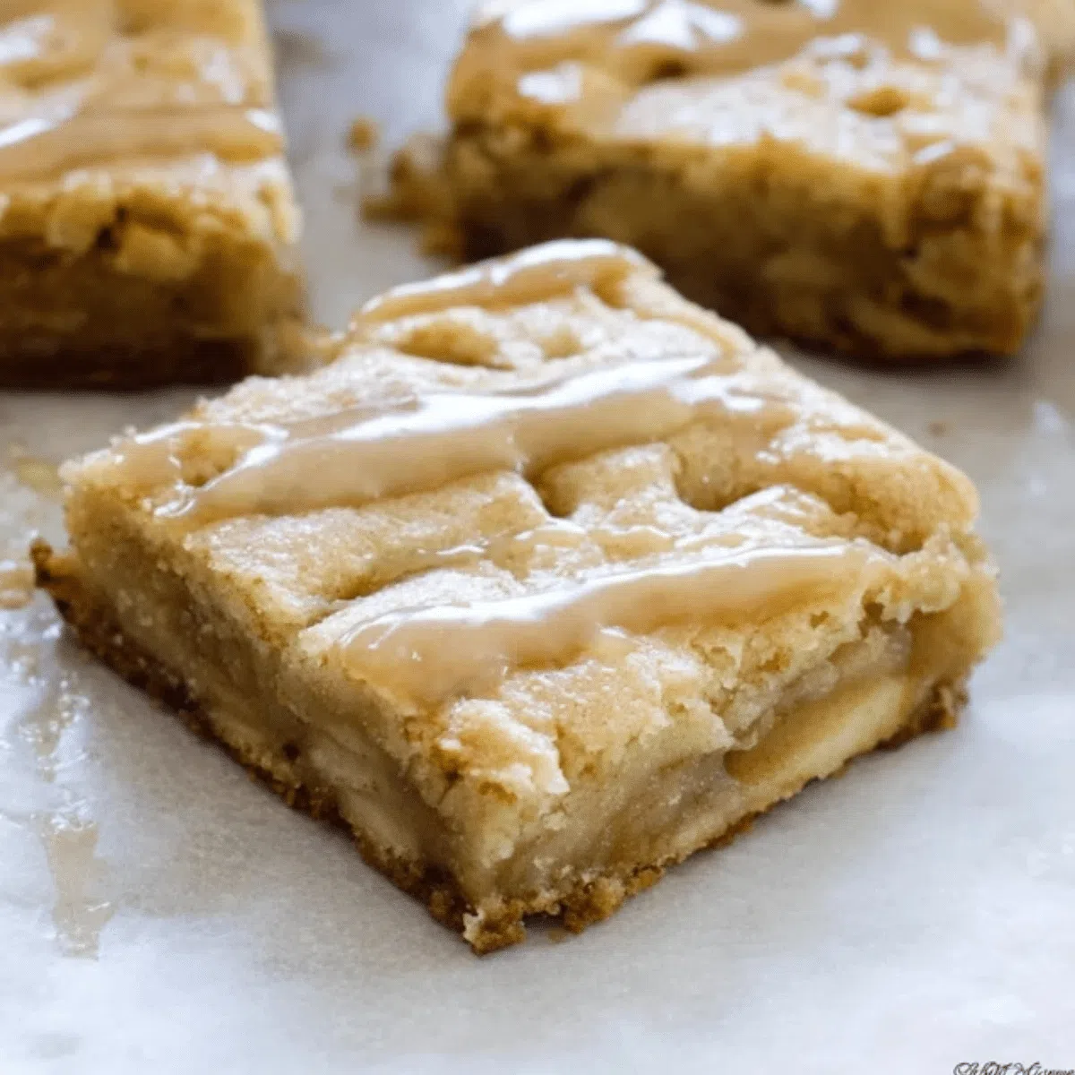 Golden maple glazed apple blondies with a sweet drizzle.