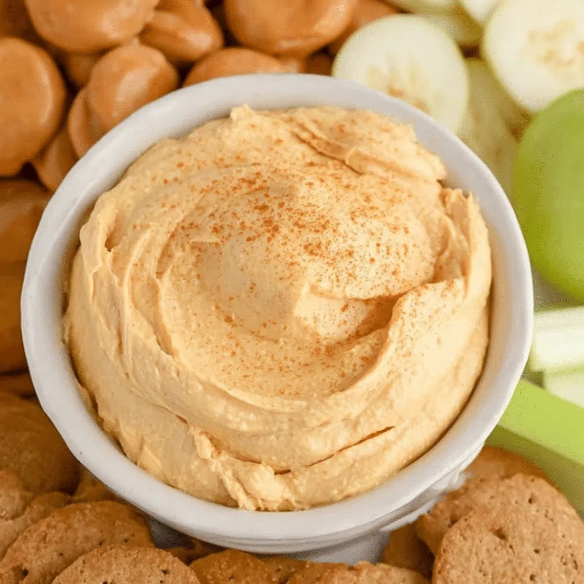 Easy no-bake pumpkin pie dip in a bowl with graham cracker dippers.