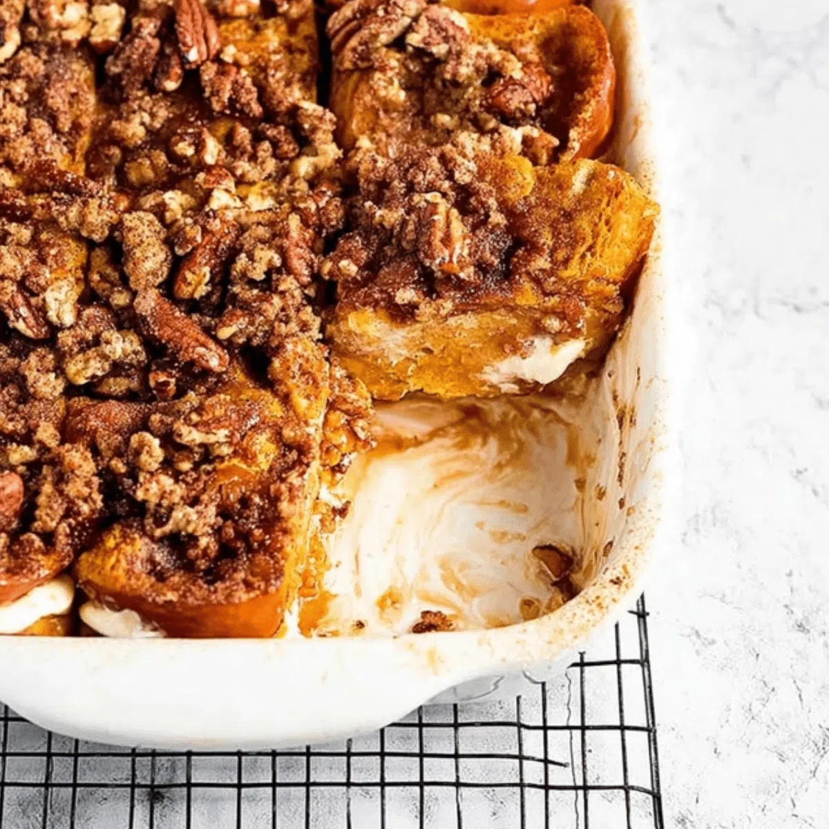 Delicious pumpkin French toast bake, golden brown with maple syrup drizzle, ready for an easy fall breakfast.