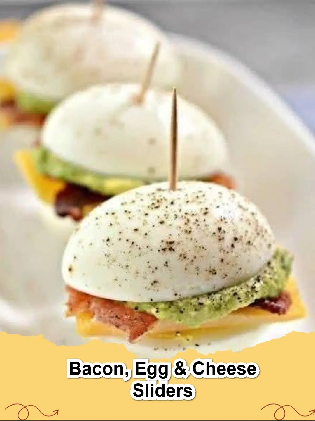 Close-up of golden brown Bacon, Egg & Cheese Sliders with melted cheese and crispy bacon, ready to serve on a rustic wooden board.