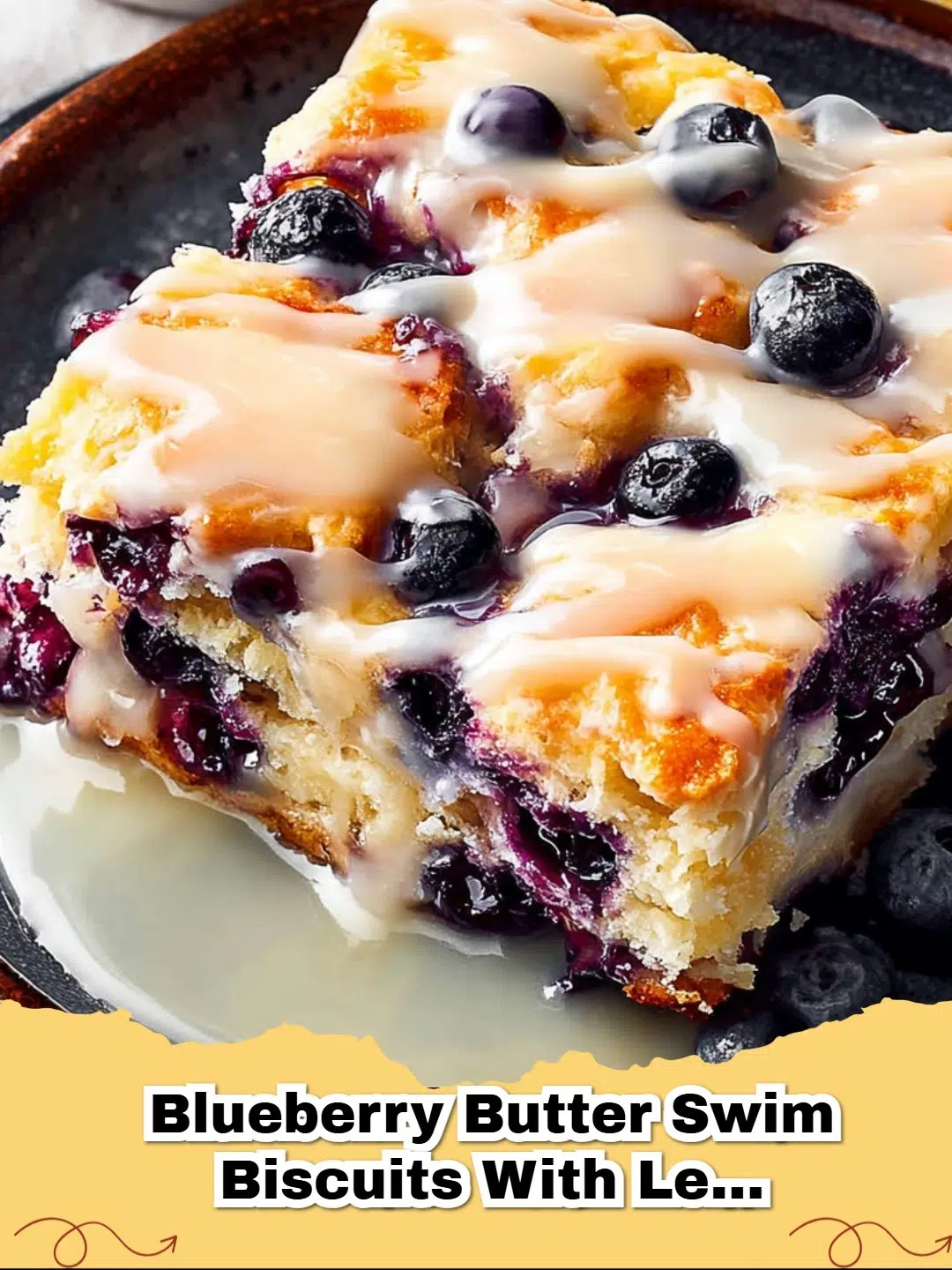 Delicious Blueberry Butter Swim Biscuits with Lemon Glaze, golden brown and glistening with sweet lemon icing, served on a white plate.