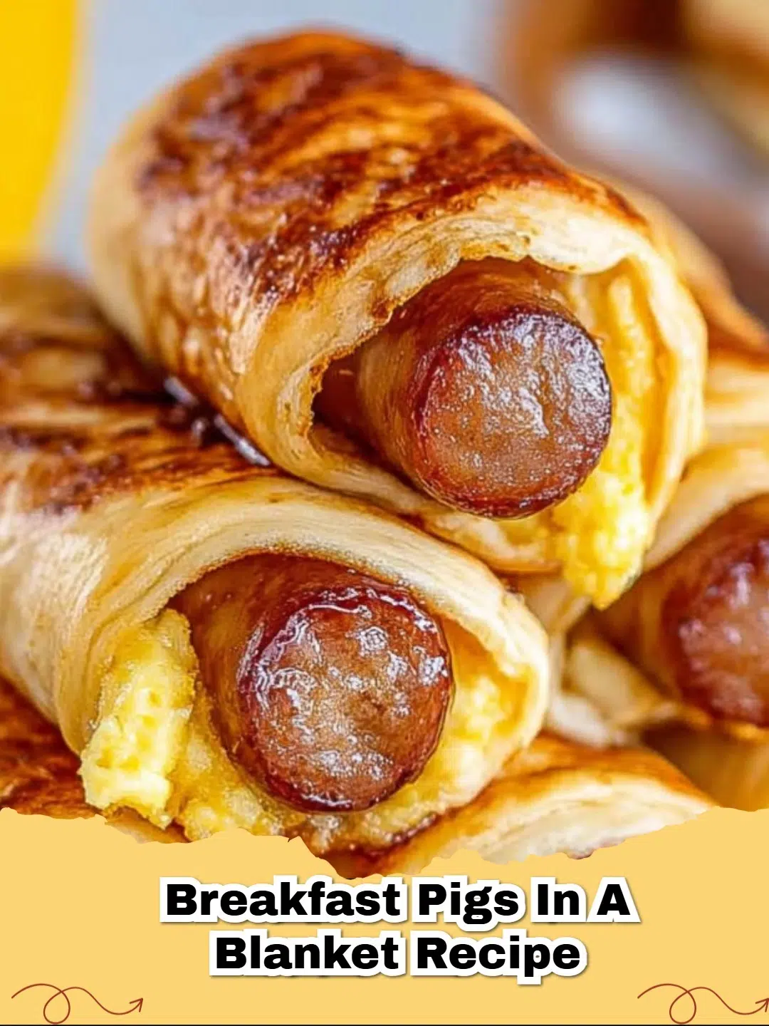 Golden brown Breakfast Pigs in a Blanket with scrambled eggs peeking out, on a plate with a side of ketchup.