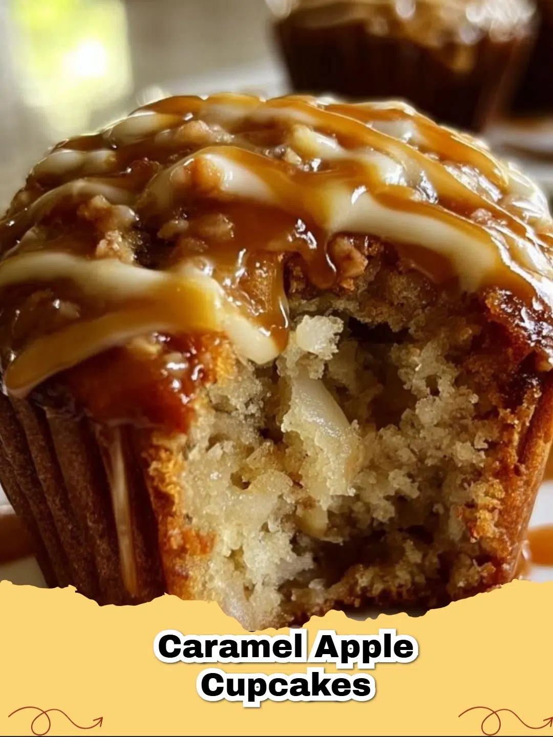 Close-up of a perfectly frosted Caramel Apple Cupcake with a caramel drizzle on a white background, highlighting its deliciousness.