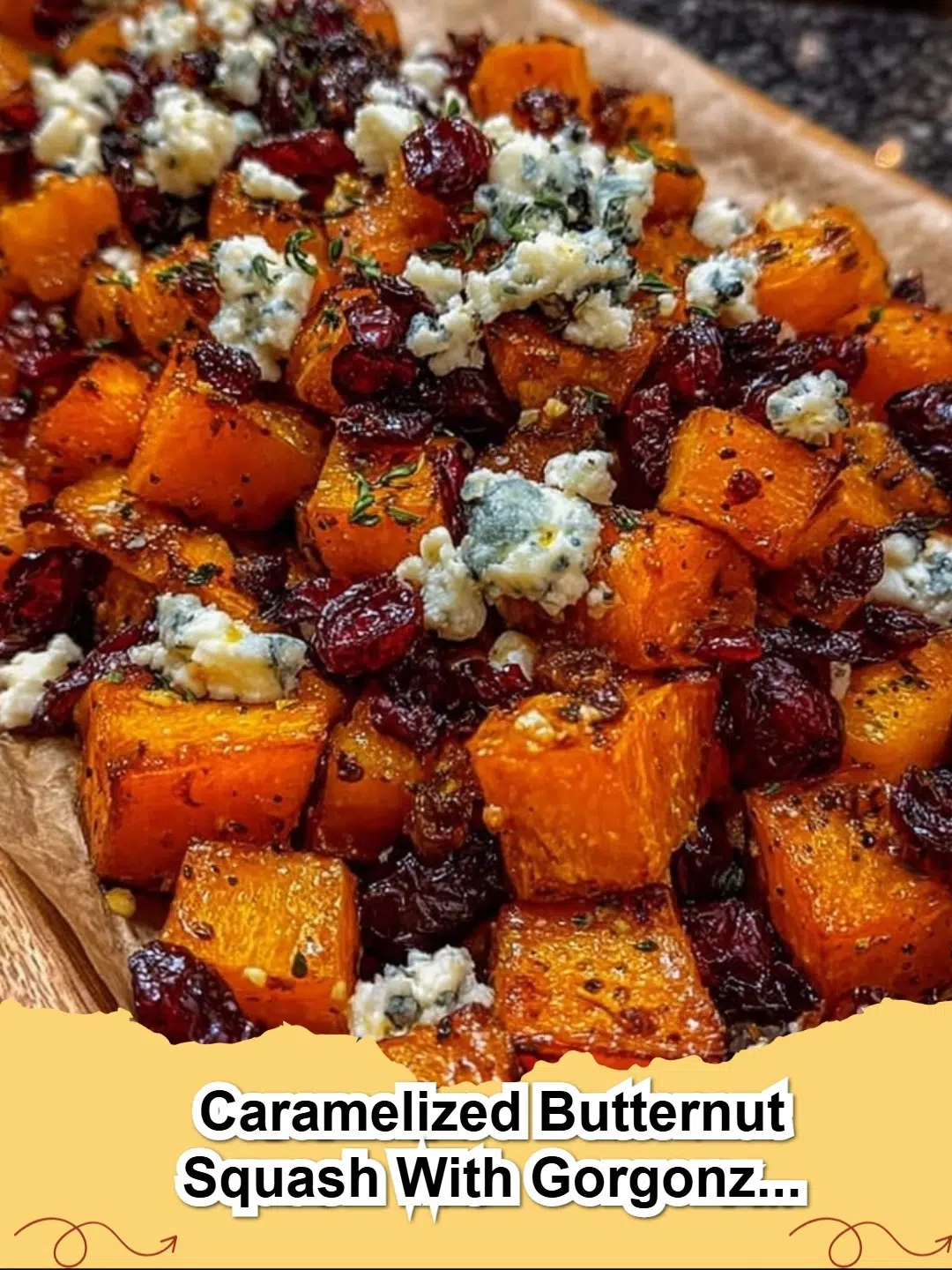 Caramelized butternut squash with crumbled Gorgonzola and a glistening cranberry-balsamic glaze, perfect for a festive fall meal.
