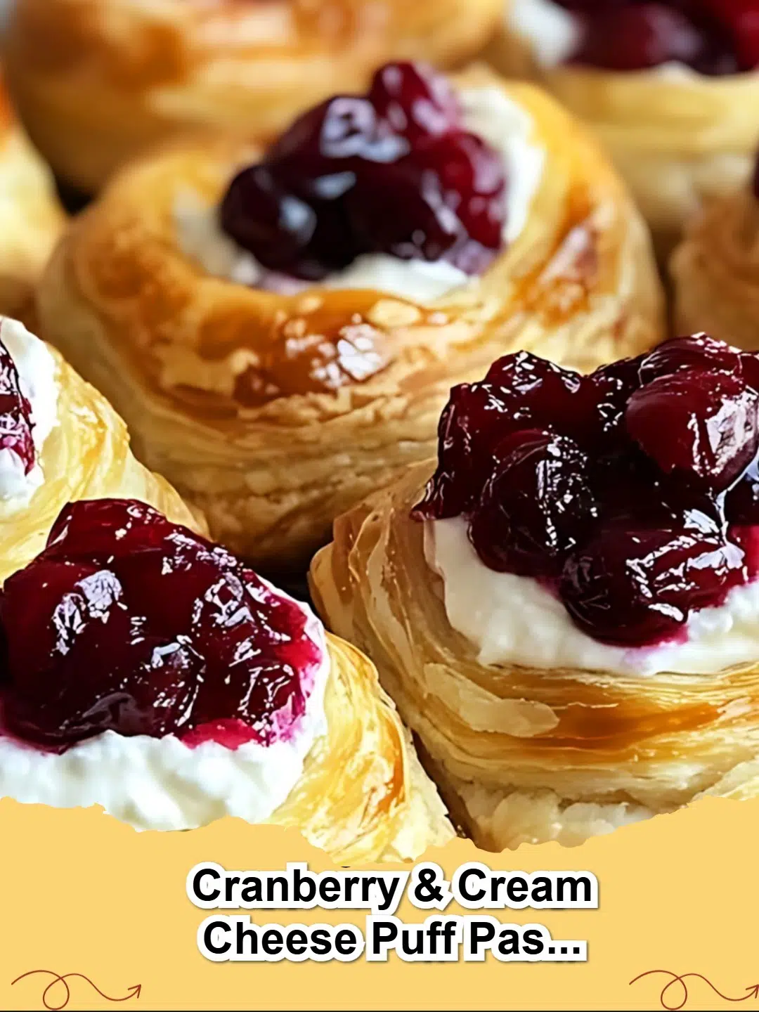 Close-up of golden brown Cranberry & Cream Cheese Puff Pastry Blossoms dusted with powdered sugar