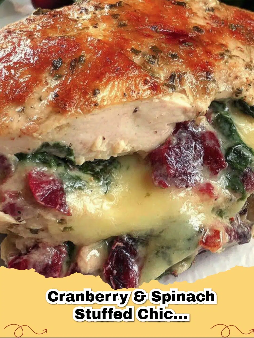 Two golden-brown Cranberry & Spinach Stuffed Chicken Breasts with Brie, sliced to show the creamy filling.