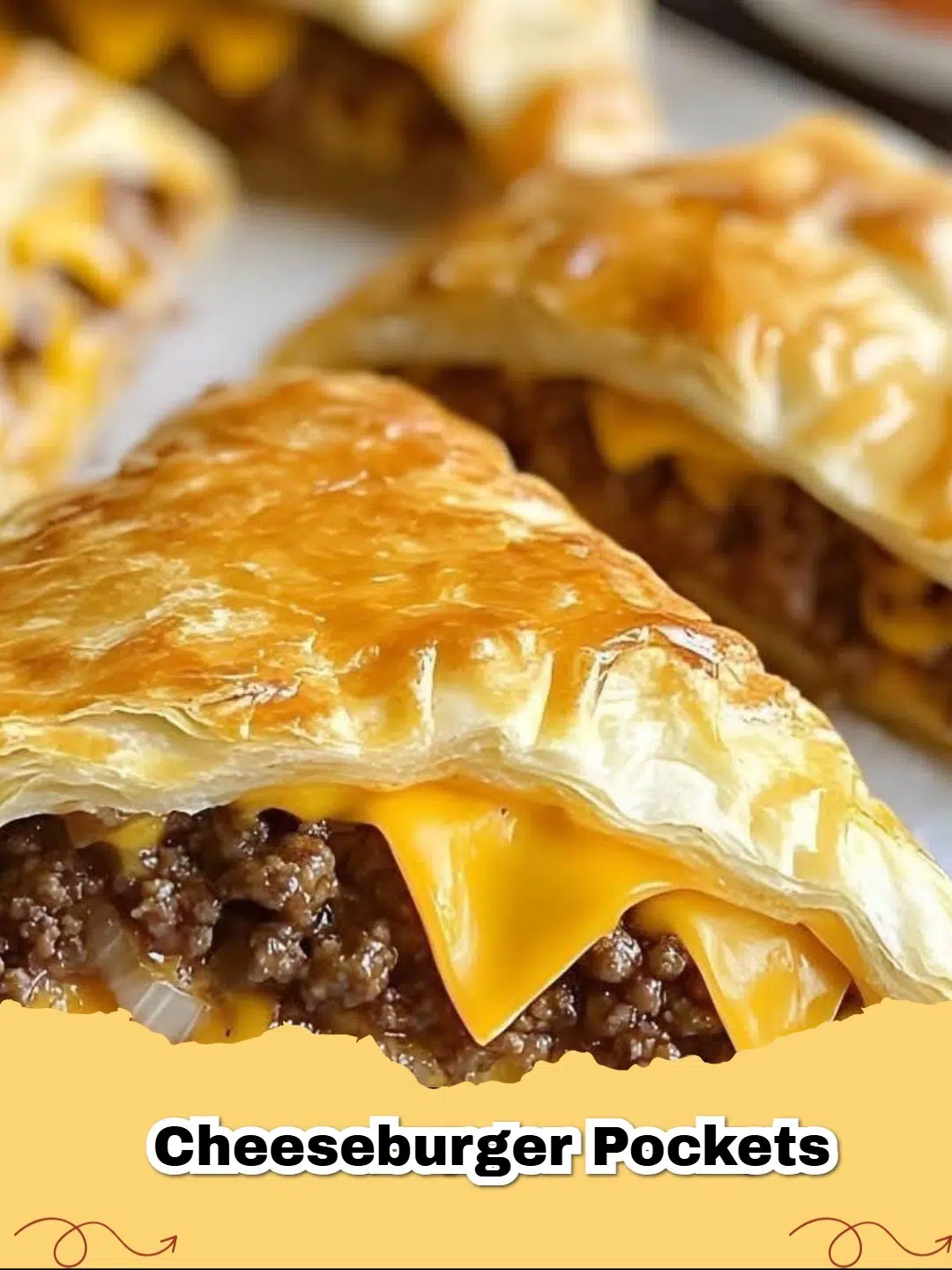 Golden brown homemade cheeseburger pockets on a baking sheet, filled with savory ground beef and melted cheddar cheese.