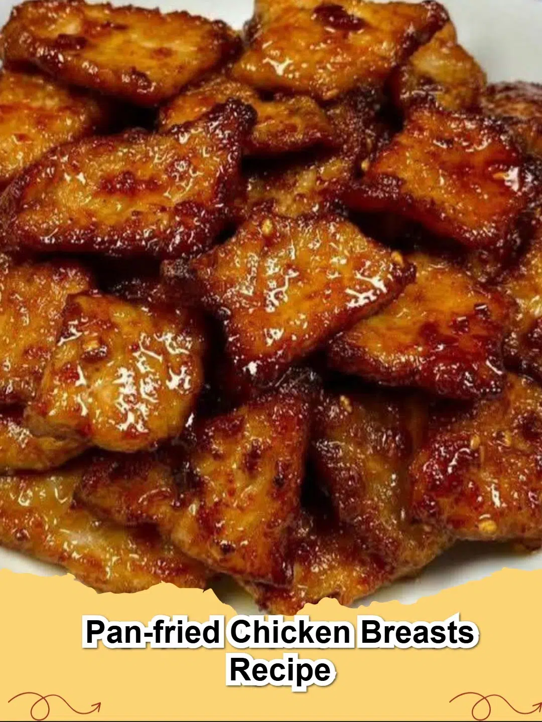 Close-up of golden brown pan-fried chicken breasts in a skillet, garnished with fresh herbs.