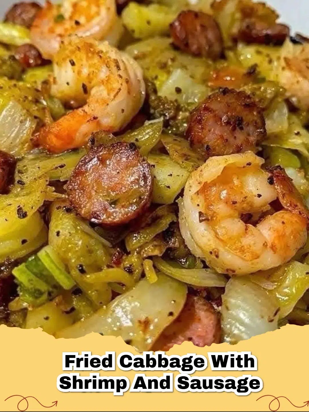 A close-up of a skillet filled with savory fried cabbage, juicy pink shrimp, and browned sausage slices, seasoned and ready to serve.