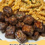 Garlic Butter Steak Bites and Spicy Cajun Alfredo Twisted Pasta served in a bowl, garnished with fresh parsley.