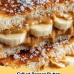 Delicious golden brown grilled peanut butter banana sandwich on a cutting board, sliced in half, with melted peanut butter and banana slices visible.