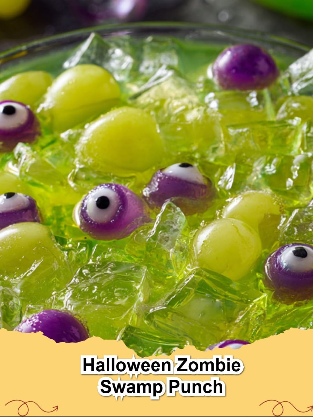 A vibrant green Halloween Zombie Swamp Punch in a large glass bowl with gummy worms and scoops of lime sherbet, perfect for spooky parties.