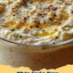 Creamy White Garlic Pizza Sauce in a bowl on a wooden board, ready for pizza making.