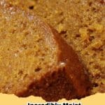 Slice of incredibly moist pumpkin bread with a crumbly topping on a wooden board