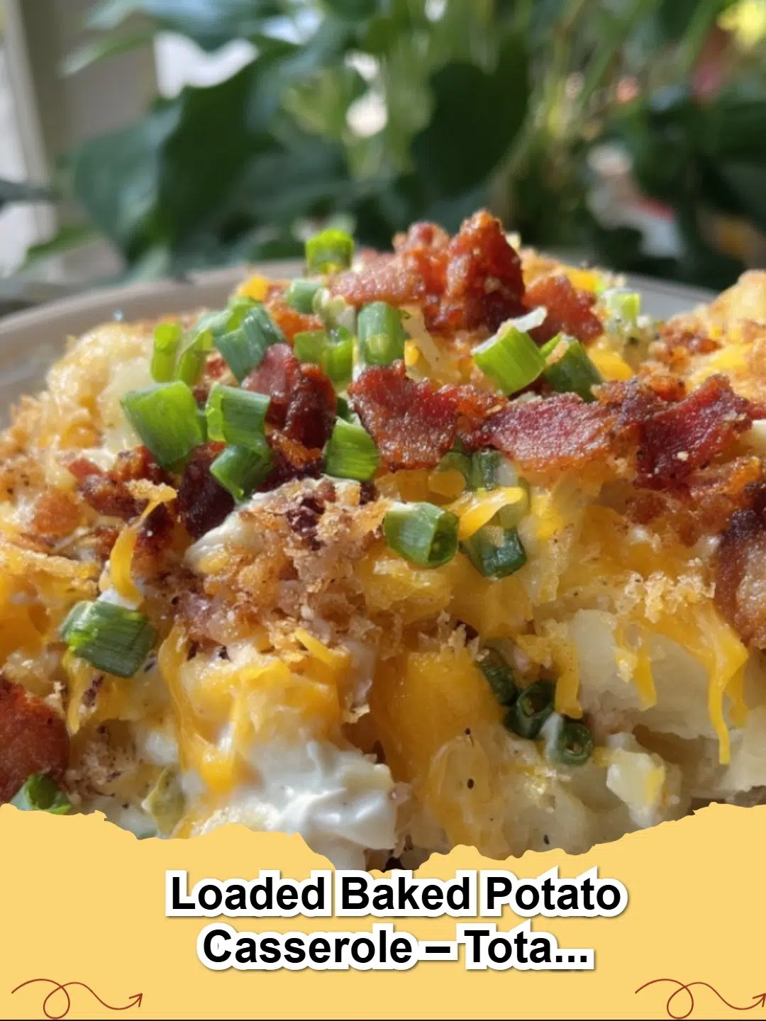 A bubbly, golden-brown Loaded Baked Potato Casserole topped with melted cheese, crispy bacon, and fresh green onions, ready to serve.