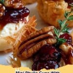 Close-up of baked Mini Phyllo Cups filled with melted brie, toasted pecans, and a glistening cranberry honey drizzle, ready to serve.