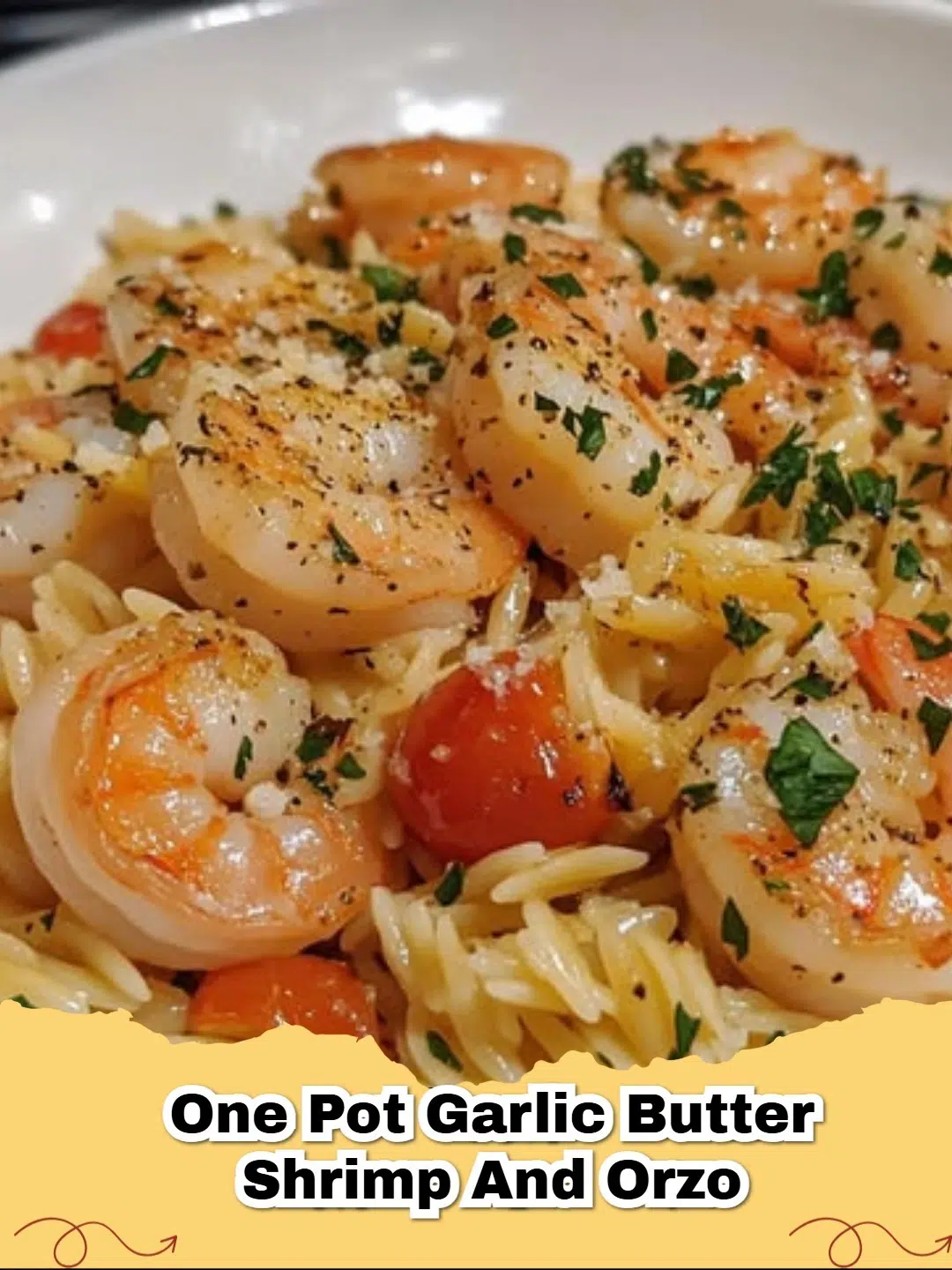 One Pot Garlic Butter Shrimp and Orzo pasta dish with fresh parsley and lemon wedges
