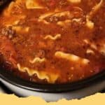 A close-up of a steaming bowl of hearty Lasagna Soup, garnished with creamy ricotta, melted mozzarella, and fresh parsley, ready to eat.