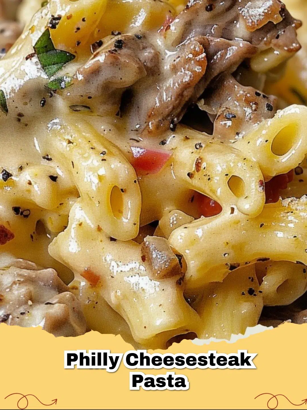 Close-up of creamy Philly Cheesesteak Pasta in a skillet, topped with melted cheese and fresh parsley