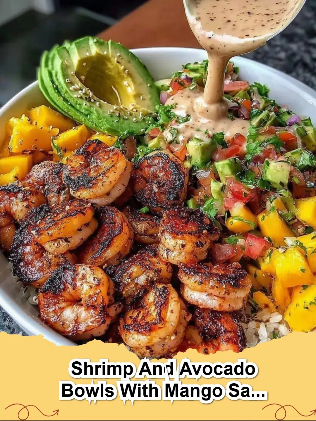 Close-up of a vibrant Shrimp and Avocado Bowl with Mango Salsa and Lime-Chili Sauce.