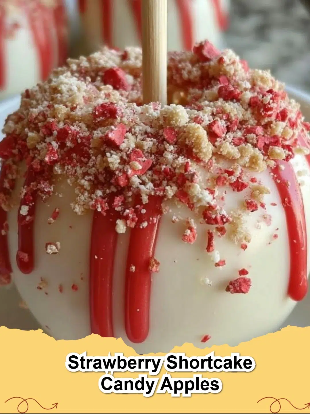 Delicious Strawberry Shortcake Candy Apples coated in white chocolate and crunchy strawberry crumb topping on a platter