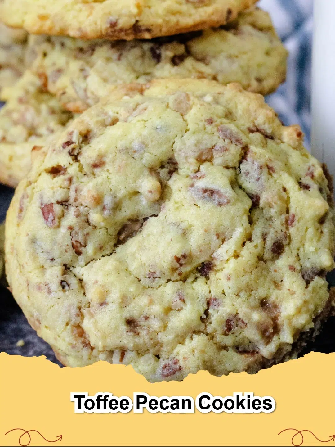 A close-up of freshly baked golden brown toffee pecan cookies on a cooling rack, showing melted toffee and crunchy pecans.
