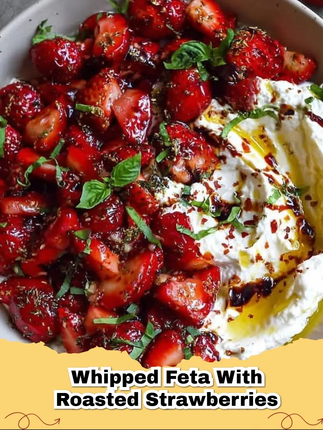 Creamy whipped feta topped with glistening roasted strawberries, served as an elegant appetizer on a white plate.