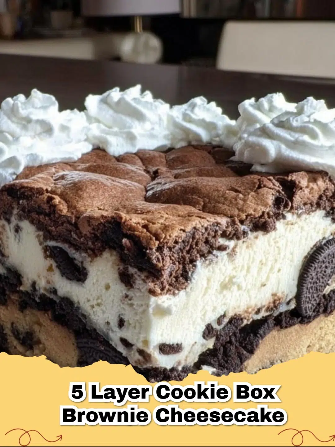 Slice of decadent 5 Layer Cookie Box Brownie Cheesecake showing distinct layers of cookie, brownie, and creamy cheesecake