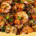 A steaming bowl of Authentic Shrimp Dirty Rice with sausage and beef, garnished with fresh green onions.