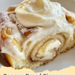 Delicious homemade banana bread cinnamon rolls with gooey cinnamon filling and a generous swirl of cream cheese frosting, ready to eat.