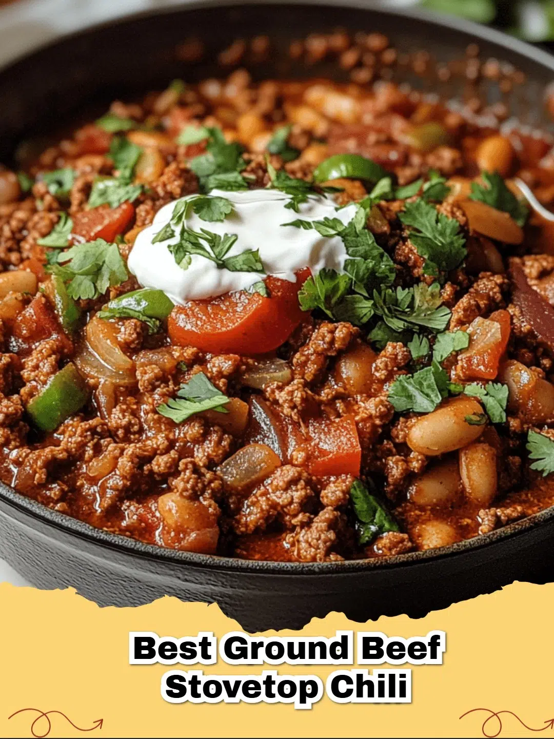 A steaming bowl of Best Ground Beef Stovetop Chili topped with cheese and sour cream