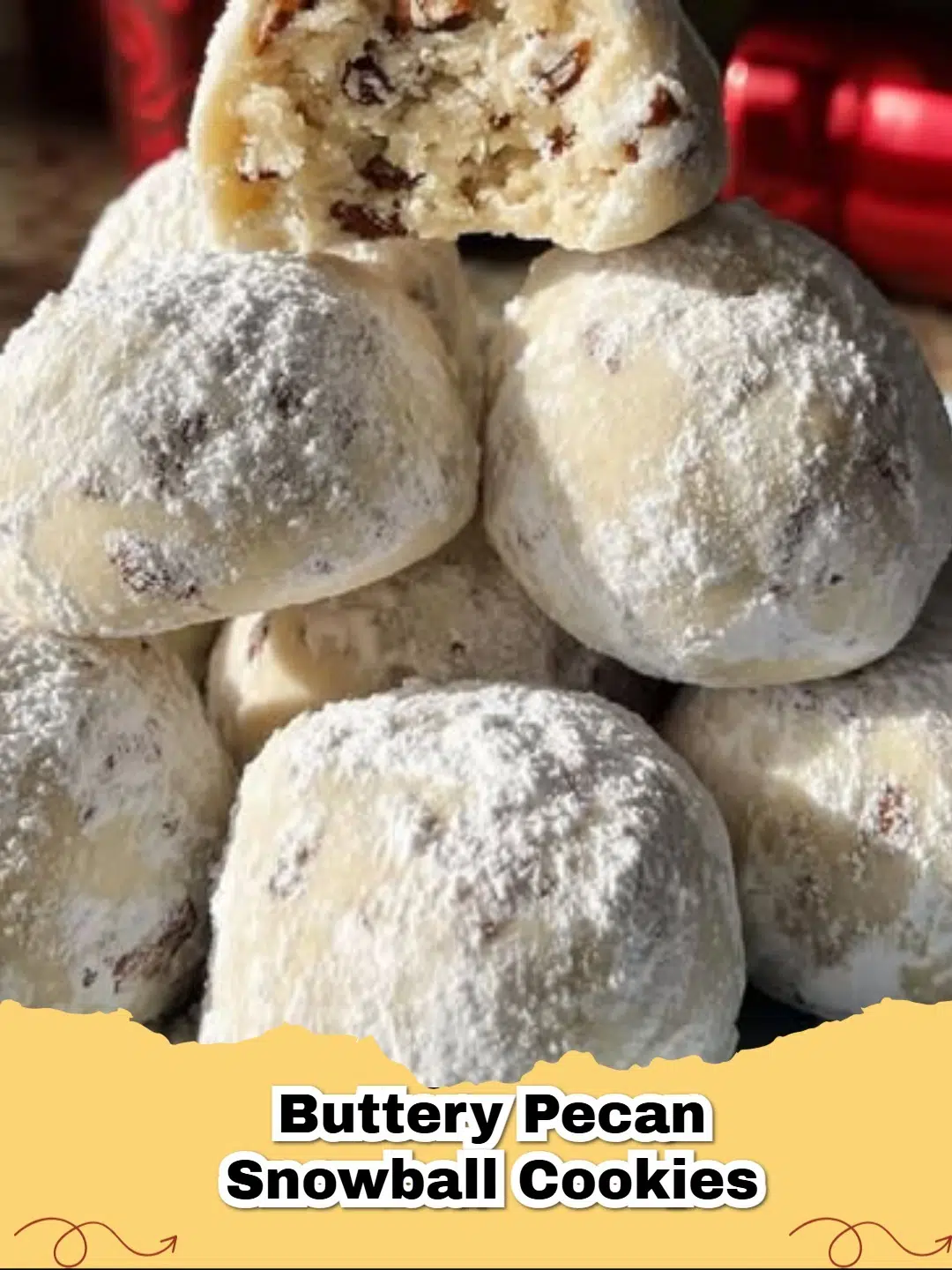 Pile of white powdered sugar coated Buttery Pecan Snowball Cookies on a white plate with green holly garnish, ready for Christmas.