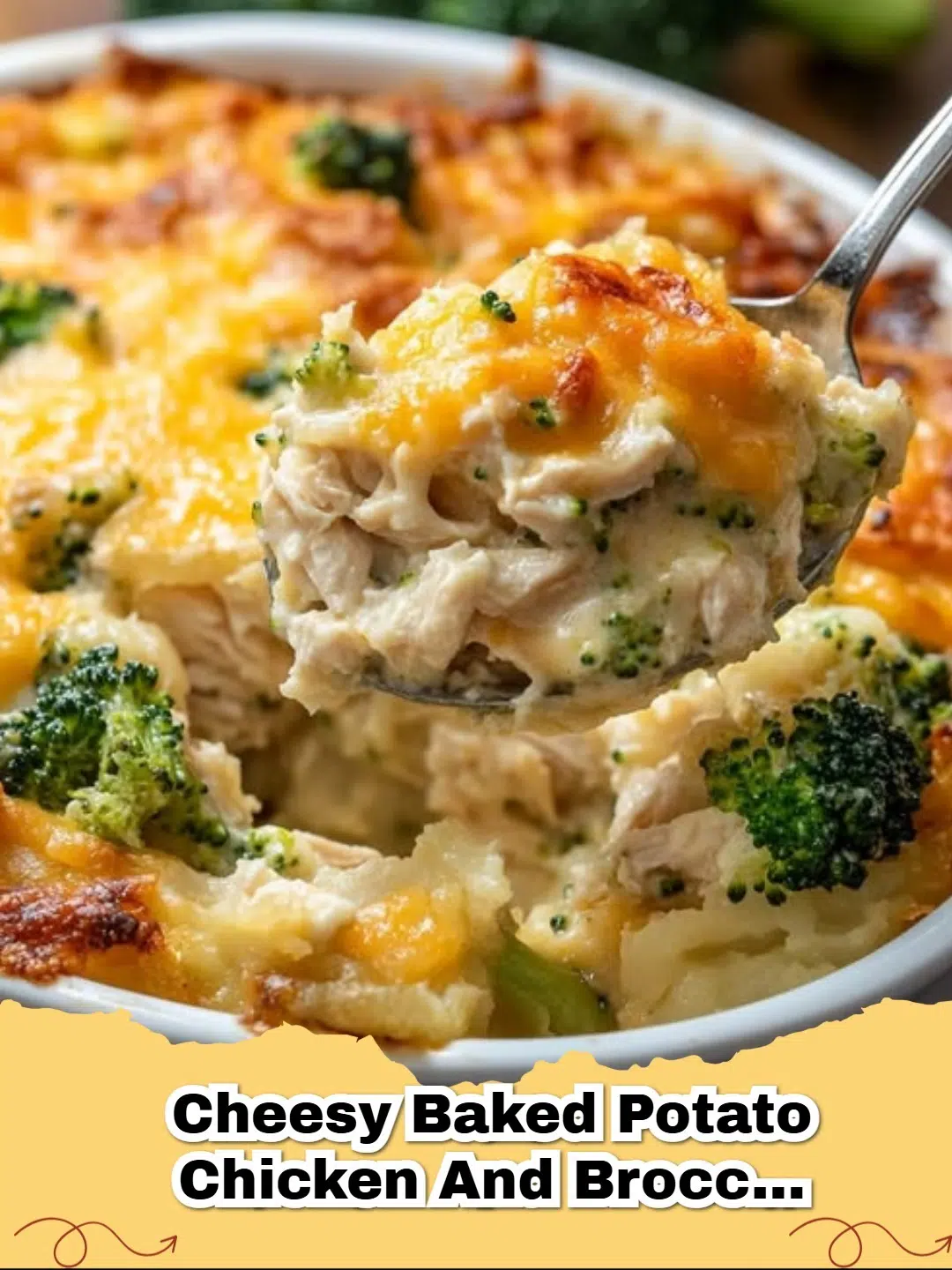 A golden-brown Cheesy Baked Potato Chicken and Broccoli Casserole in a baking dish, fresh from the oven, with a serving spoon.