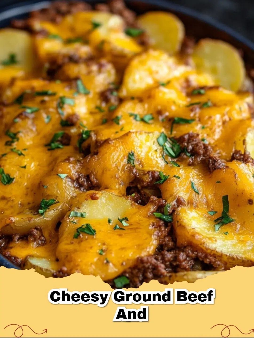 Close-up of a skillet filled with bubbling Cheesy Ground Beef and Potatoes, topped with melted cheddar cheese and fresh parsley.