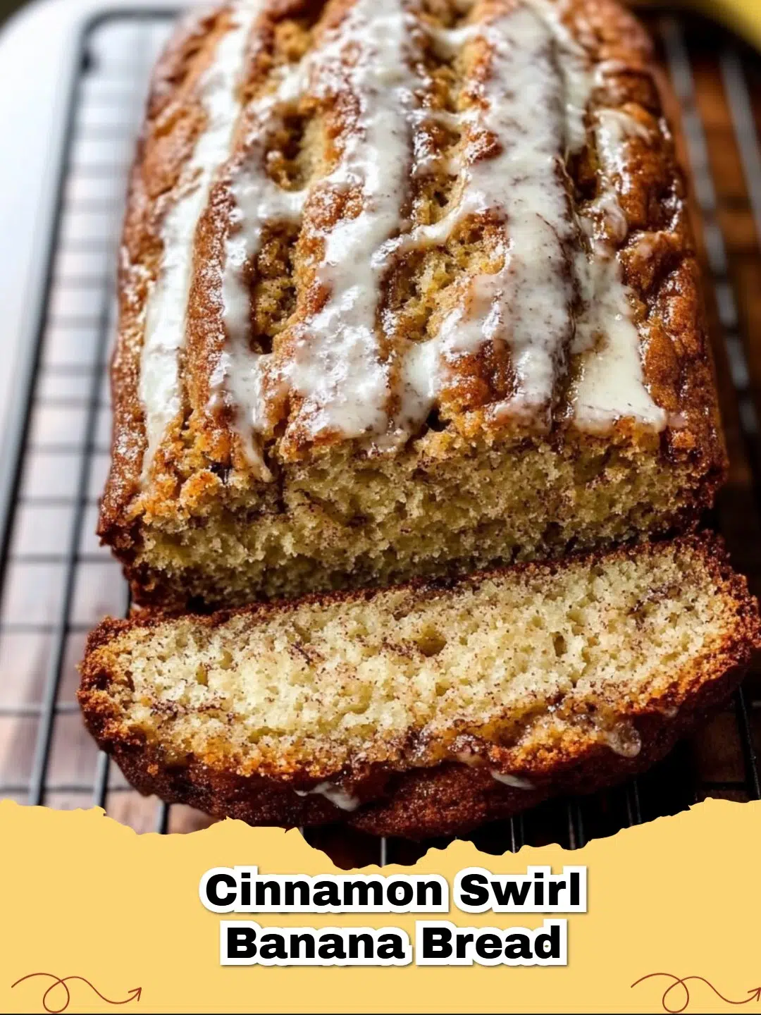Slice of moist Cinnamon Swirl Banana Bread with a visible cinnamon ribbon, garnished with fresh bananas on a rustic wooden board.