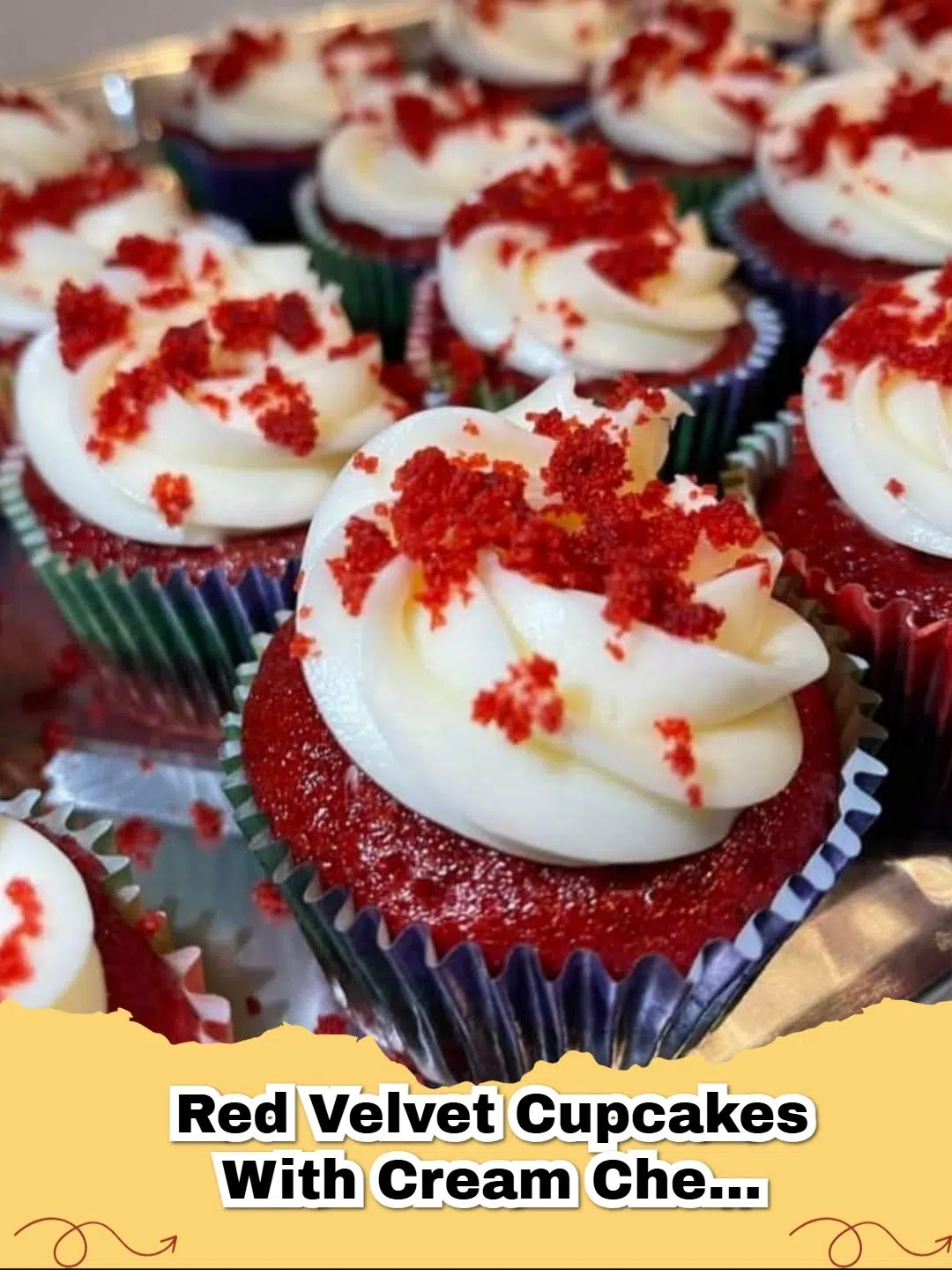 Decadent Red Velvet Cupcakes topped with swirl of creamy white cream cheese frosting and a sprinkle of red velvet crumbs.