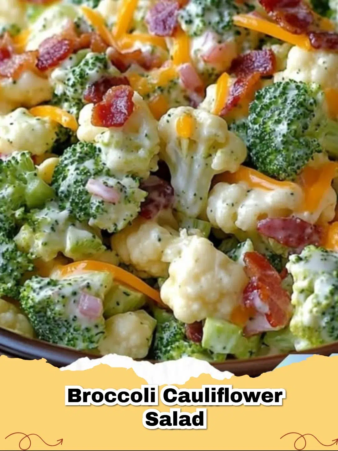 A bowl of creamy bacon broccoli cauliflower salad on a wooden table, garnished with fresh parsley.