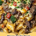 A close-up of creamy cheesy garlic steak pasta shells with broccoli and red bell peppers, garnished with fresh parsley.