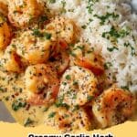 Delicious Creamy Garlic Herb Shrimp with Rice served in a bowl, garnished with fresh herbs.
