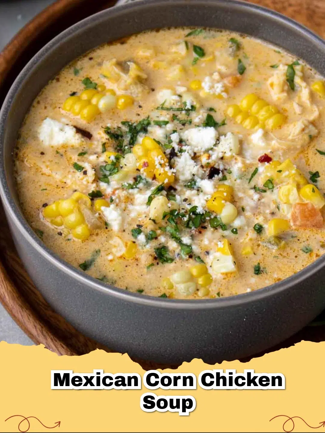 A steaming bowl of creamy Mexican chicken and corn soup, garnished with fresh cilantro and cotija cheese.