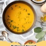Bowl of creamy roasted butternut squash soup garnished with a swirl of cream and fresh herbs