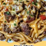 Delicious Creamy Roasted Red Pepper Steak Alfredo Spaghetti garnished with fresh parsley.